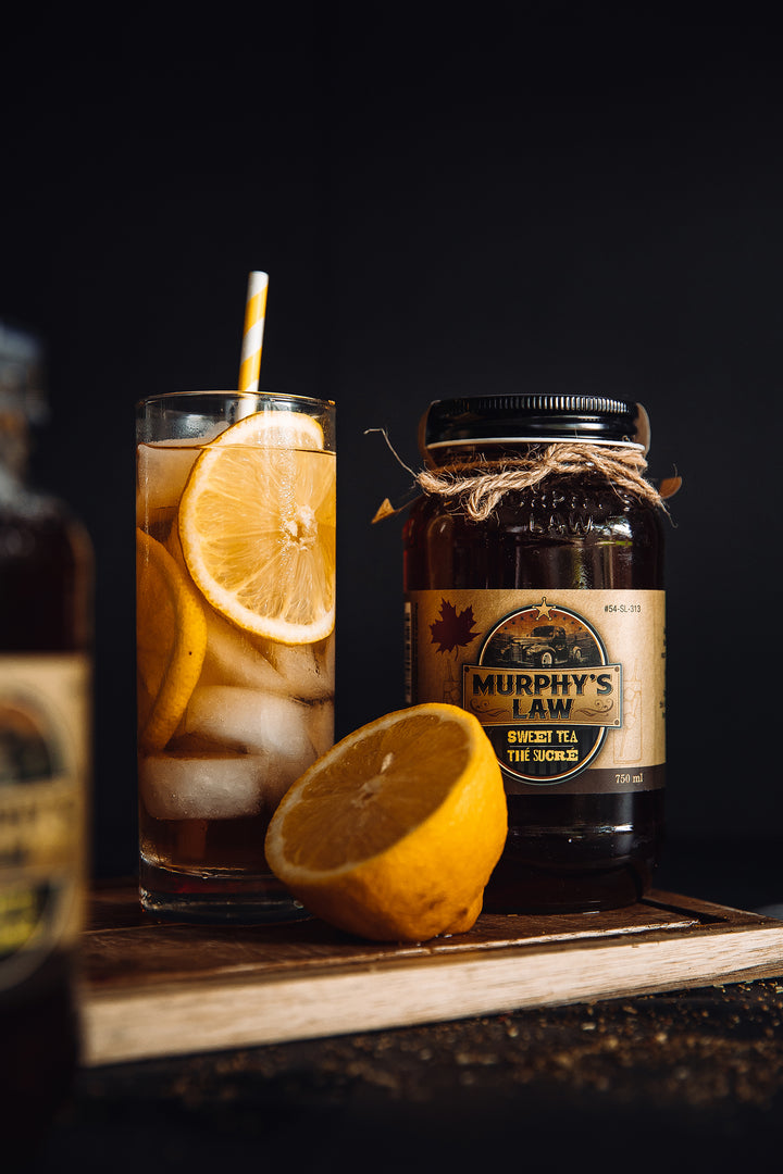Murphy's Law Sweet Tea Moonshine refreshingly mixed into lemonade highlighted by yellow swirl straw